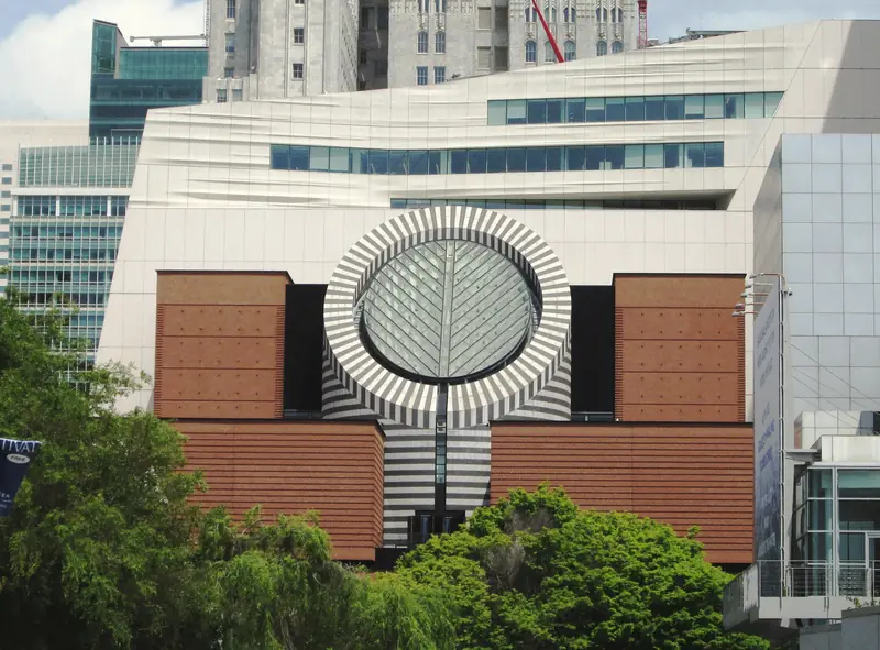Photo of the SFMOMA building and its round skylight seen from Yerba Buena Gardens